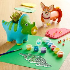 an assortment of toys and crafts sitting on a table