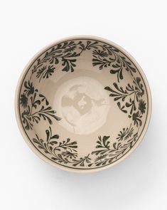 a black and white bowl on a white background with an image of the earth in it