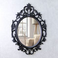 a round mirror hanging on the wall