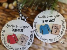 two personalized christmas ornament hanging from a pine tree with the words santa gaur your snapah and other clothes on it