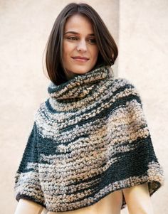 a woman is wearing a knitted shawl