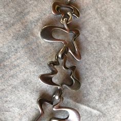 "This iconic heavy sterling silver bracelet is vintage Georg Jensen, Denmark. It was designed in the 1940s by Henning Koppel, for Georg Jensen (his initials HK are on the clasp), known for his beautifully expressed flowing designs. The matching earrings have beautiful little silver screws on the back but could be replaced with posts for pierced ears by a good jeweler. The bracelet has 6 free form links and is approximately 8 inches long. Because of the thickness of the silver, when closed it is Georg Jensen Silver, Brown Leather Gloves, Flow Design, Georg Jensen, Chain Link Bracelet, Matching Earrings, Sterling Silver Bracelets, Ear Piercings, Making Ideas