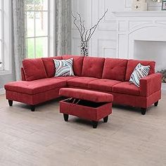 a living room with a red couch and ottoman