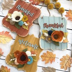 three wooden signs with flowers and leaves on them that say welcome, beautiful, welcome