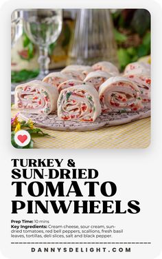 an advertisement for turkey and sun dried tomato pinwheels on a table with wine glasses