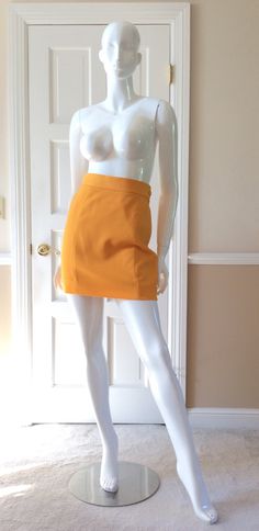 "This vintage Moschino skirt is in his iconic taxi cab/school bus yellow.  Fully lined in yellow rayon.  Side zipper with self button.  Front and back shaping seams.  Measurements -  Waist - 27' Hips - 36\" Length - 18\"" Fitted Yellow Skirt For Fall, Retro School Mini Skirt With Lining, Retro Mini Length Bottoms For School, Retro Fitted Skort For Fall, Fitted Retro Skort For Fall, Yellow Workwear Bottoms Shorts, Yellow Short Bottoms For Work, Yellow Short Length Bottoms For Workwear, Yellow Short Length Workwear Bottoms