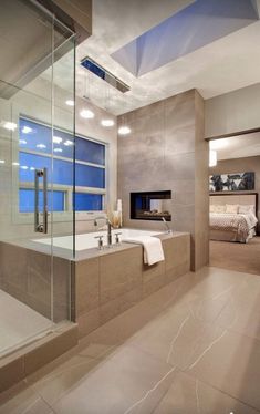 a bathroom with a tub, sink and large window