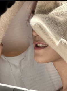 a close up of a person with a towel on their head