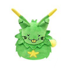 a green stuffed animal with yellow horns on it's head and eyes, sitting in front of a white background