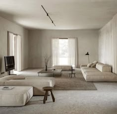 a living room filled with lots of furniture and a flat screen tv mounted on the wall