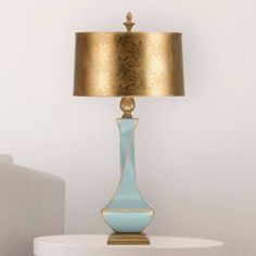 a blue lamp sitting on top of a white table