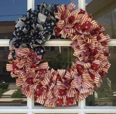 an american flag wreath hanging on the front door