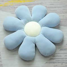 a blue flower shaped object sitting on top of a piece of paper