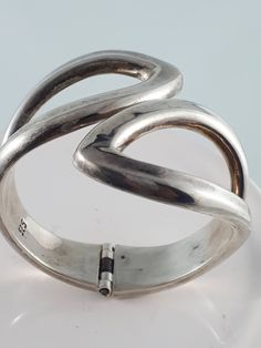 "This is a nice chunky hinged Sterling Silver cuff. SKU-330  Its simple design is easy to wear and live with every day.  Although the cuff is 8\" around the wrist, it can be worn up the arm comfortably if you have a small wrist. The hinge mechanism makes it easy to open the cuff and slip it on.  This cuff is solid, and has a nice weight to it. D E T A I L S: Measures approx. 8.0 inches long x 2.5\" wide. Weighs approx. 57.9 grams Hallmark: Stamped \"925 \"inside the cuff Condition: Very good vin Hand Cuff Aesthetic, Silver Vintage Jewelry, Vintage Silver Cuff Bangle, Vintage Adjustable Silver Cuff Bracelet, Heavy Vintage Silver Cuff Bracelet, Silver Arm Cuff, Vintage Silver Hallmarked Cuff Bracelet, Silver Outfits