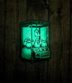 a green light that is on the side of a wooden wall with ghost dogs in a glass case