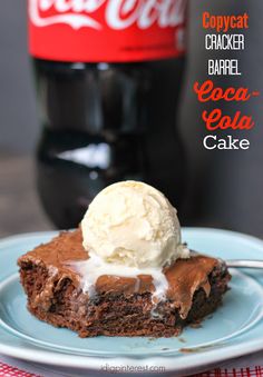 a piece of chocolate cake with ice cream on top and coke bottle in the background