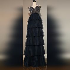 A Navy Blue Gown With Intricate Beadwork Adorning The Upper Half. The Lower Half Is Composed Of Layered Sheer Material That Visually Enhances The Wearer's Height. Additionally, The Bottom Is Lined On The Inside For Added Comfort. Size: Small Condition: New With Tag Originally Purchased At Nordstrom's. Additional Beads Still Attached. Navy Blue Gown, Sheer Material, Bustier Dress, Bustiers, Women Lace, Beaded Lace, Blue Beads, Homecoming, Homecoming Dresses