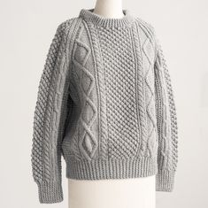 a gray sweater on a mannequin head