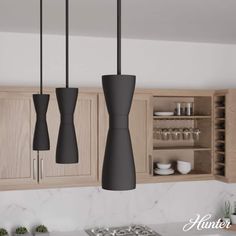 three lights hanging from the ceiling in a kitchen