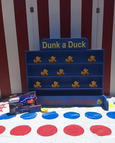 a table topped with lots of toys next to a red white and blue striped wall