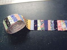 a roll of washi tape sitting on top of a black table next to a keyboard