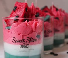 three glasses filled with pink and green desserts on top of a table next to each other