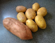 a pile of potatoes sitting on top of a counter