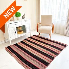 a living room with a rug and chair