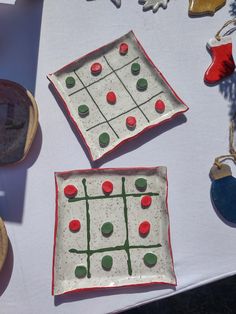 two ceramic plates sitting on top of a table covered in ornaments and other things to make it look like they have been made out of clay