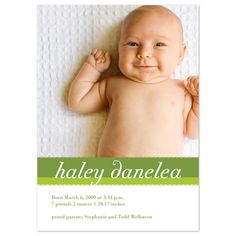 a baby is laying down on a blanket with the words haley danielle written in green