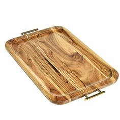 a wooden cutting board with brass handles on a white background and clippings to the side