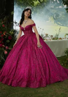 Embrace the magic of your quinceaera in this enchanting Vizcaya ball gown (style 89455). The off-the-shoulder bodice is crafted from a subtly sheer fabric, offering a touch of ethereal beauty. The bust is delicately draped, highlighting your unique silhouette, while peek-a-boo jewel beading adorns the lovely sweetheart neckline, adding a touch of sparkle.The real magic unfolds in the skirt, made from intricately patterned glitter tulle. This luxurious fabric boasts an unreal sparkle that will ca Luxury Glitter Tulle Gown For Quinceanera, Magenta Ball Gown, Magenta Quinceanera Dresses, Fairy Tale Dress, Bolo Rapunzel, Pink Ball Gown, Jewel Encrusted, Sheer Corset, Quince Dress