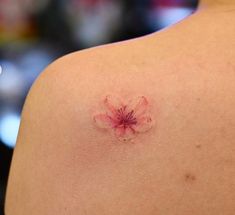 a woman's back with a small flower on it