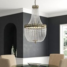 a chandelier hanging from the ceiling in a dining room