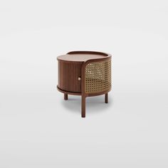 the side table is made out of wood and has an intricate rattand design