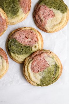 matcha neapolian sugar cookies with pink and green frosting on top