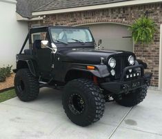 a black jeep parked in front of a house