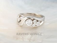 a white gold ring with three diamonds on it