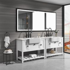 a bathroom with two sinks and a large mirror on the wall next to an open door