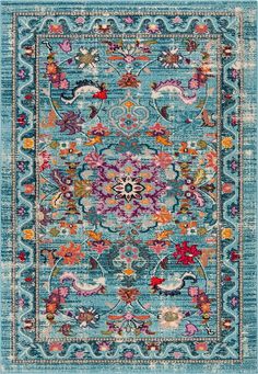 a blue area rug with an ornate design on the front and back side, in various colors