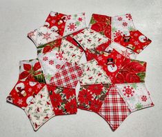 a pile of red and white quilted christmas napkins