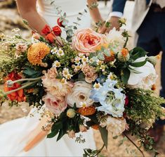 the bride and groom are holding their bouquets