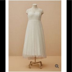 a white dress on a mannequin stand