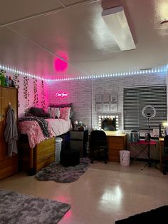 a bedroom with pink lights on the ceiling