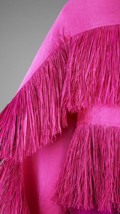 This fringing is everything. Part of Cameroonian fashion designer Imane Ayissi’s Mbeuk Idourrou collection. Mbeuk Idourrou translates to ‘He or she who wears a garment that is impressive’. It's a self-fulfilling prophecy. The ensemble is comprised of palazzo trousers and cape in fuschia satin, the cape and top are fringed with dyed pink raffia from Madagascar. Garment Details, Palazzo Trousers, Pink Wrap, South Kensington, He Or She, Color Rosa, Madagascar