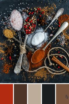 spoons filled with various spices on top of a table