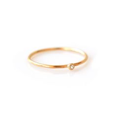 The most versatile and dainty piece in our collection, this solo diamond ring can be stacked with nearly everything. Simplistic and minimalist, it adds extra sparkle to any ring stack. Product Description: solid 14kt gold; 1mm ring band; 1pt diamond (clarity VS1/2) and (size 0.25 carats) Cheap Diamond Rings, Trio Ring, Gold Rings Simple, Diamond Stacking Rings, Bezel Set Diamond, Buying Diamonds, Rings Simple, Gold Diamond Rings, 14kt Gold