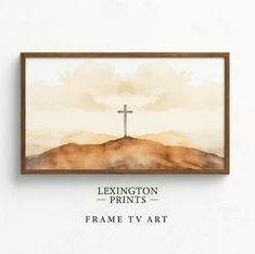 a cross on top of a hill with clouds in the background and text below it that reads, lexington prints frame tv art