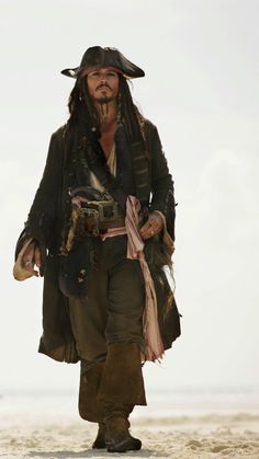 a man dressed as captain jack sparrow on the beach