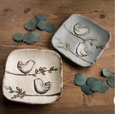 two ceramic dishes with birds painted on them